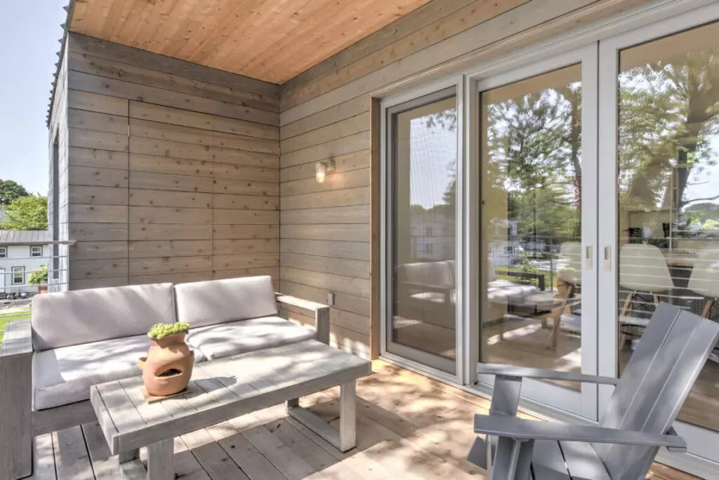 Deck with sliding doors that open into a living room.